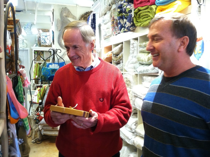 U.S. Sen. Tom Carper, D-Delaware, left, checks out a locally-made cutting board at Mod Cottage with owner Brad Holsinger. BY KARA NUZBACK